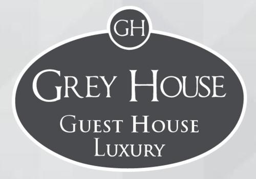 a sign that reads grey house guest house luxury at Grey House Guest House Luxury in Latina