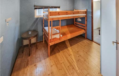 a bunk bed in a room with a wooden floor at Cozy Home In Björköby With Kitchen in Björköby