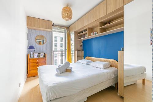 a bedroom with two beds and a blue wall at La Casita Mexicana - Kids Friendly by So Homy- 3 Bed Room - 6 PAX in Saint-Ouen