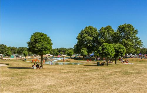 people in a park with a pond and trees at Nice Home In Hoge Hexel With Wifi in Hoge-Hexel