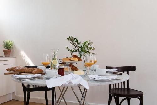 a table with bread and wine glasses on it at Palais Wunderlich in Lahr