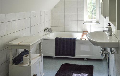 a bathroom with a tub and a sink at 4 Bedroom Lovely Home In Mariefred in Mariefred