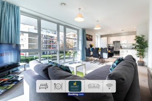 a living room with a large couch and a tv at Spacious City Center Apartment By Smart Apartments Short Lets & Serviced Accommodation Apartment Southampton With Free WiFi in Southampton