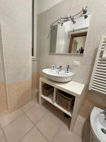 a bathroom with a sink and a mirror at Puccini Home "La Bohème" in Nola