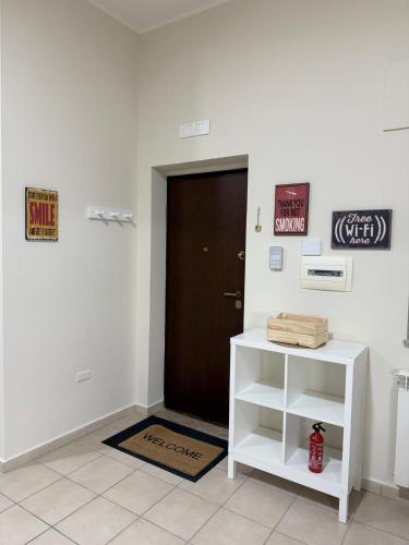 a door in a room with a white shelf and a door at Puccini Home "La Bohème" in Nola