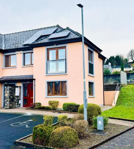 a house with a solar roof on a street at Boru Walk Townhouse -Stylish & Modern Holiday Home in Killaloe