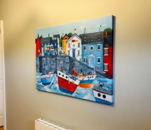 a painting of boats hanging on a wall at Boru Walk Townhouse -Stylish & Modern Holiday Home in Killaloe