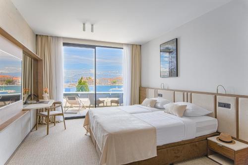 a bedroom with a large bed and a large window at Grand Hotel View in Postira