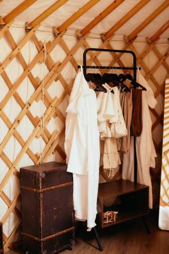 a room with a bunch of clothes hanging on a rack at Glamping Le Dune in Cinigiano