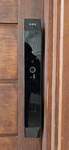 a cell phone is hanging on a wooden wall at Residence St Antoine in Cayenne