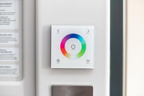a control panel with a cd on a wall at Point A London Liverpool Street in London
