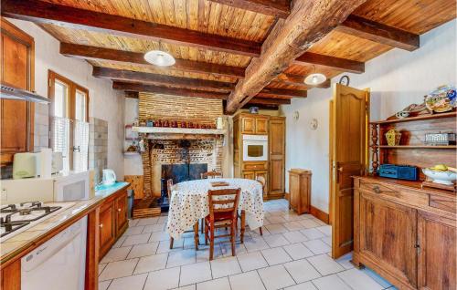 Il comprend une cuisine dotée de plafonds en bois et d'une table avec des chaises. dans l'établissement Stunning Home In St Pierre Deyraud, à La Force