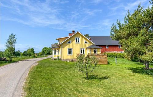 a yellow house on the side of a road at 2 Bedroom Gorgeous Home In Hyltebruk in Hyltebruk