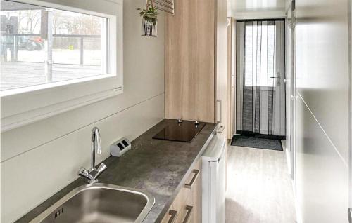 a kitchen with a sink and a window at Nice Ship In Biddinghuizen With Kitchen in Biddinghuizen