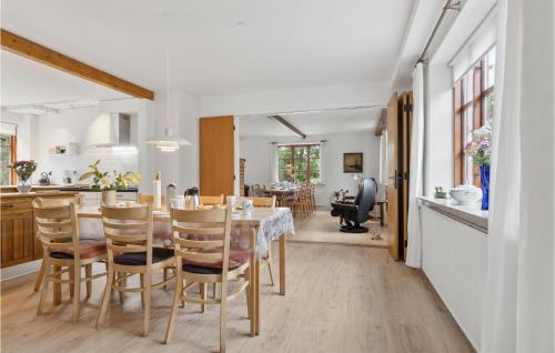 a kitchen and dining room with a table and chairs at Cozy Home In Brovst With Kitchen in Brovst