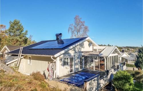 a house with solar panels on the roof at Lovely Home In Uddevalla With Kitchen in Uddevalla