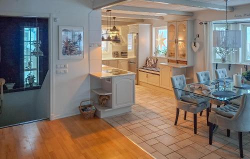 a kitchen and dining room with a table and chairs at Lovely Home In Uddevalla With Kitchen in Uddevalla