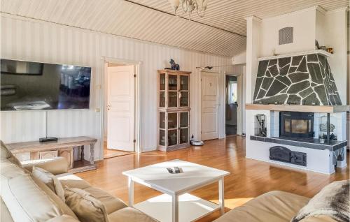 a living room with a couch and a table at Lovely Home In Uddevalla With Kitchen in Uddevalla