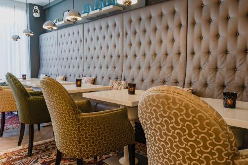 a restaurant with two tables and chairs and a wall at Hotel JL No76 in Amsterdam