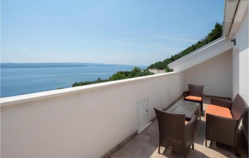a balcony with chairs and a view of the water at Villa Olive Tree Pisak in Pisak
