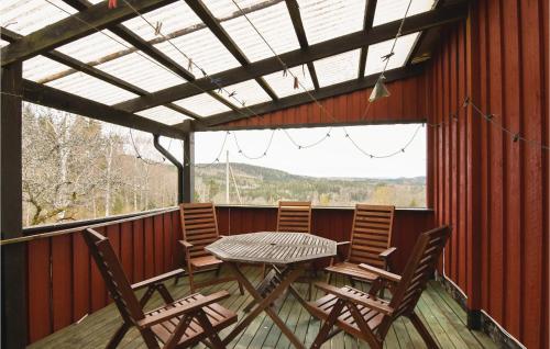 a patio with a table and chairs on a deck at Beautiful Home In Ed With Kitchen in Ed