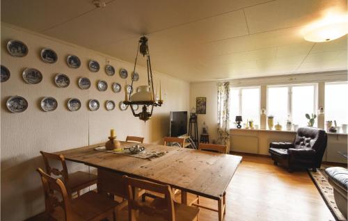 a living room with a wooden table and chairs at Beautiful Home In Ed With Kitchen in Ed