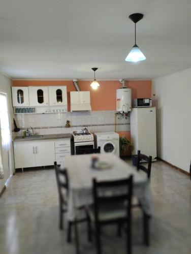 a kitchen with a table and chairs in a room at Confortable depto para 4 in Godoy Cruz