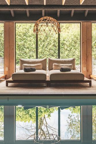 a bed sitting on a platform next to a body of water at Hotel de Sterrenberg - Adults Only in Otterlo