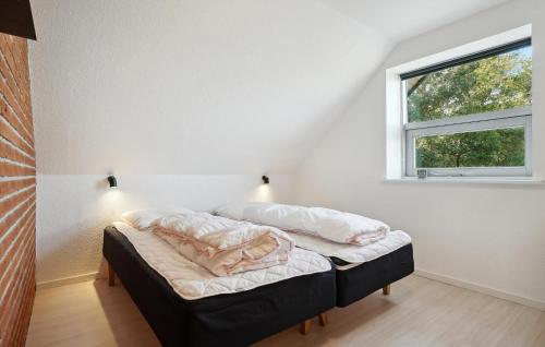 a bedroom with a bed with two pillows on it at Beautiful Home In Nykøbing M With Wifi in Nykøbing Mors