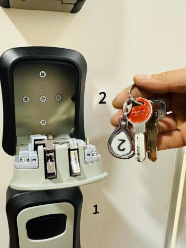 a person holding a pair of keys in a mailbox at Colombia Apartments&Rooms in Durrës