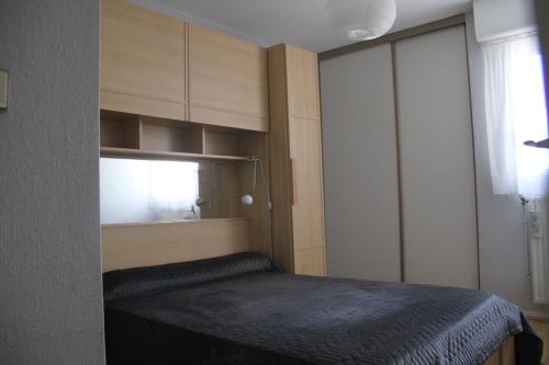 a small bedroom with a bed and a window at Harmonie in Pau
