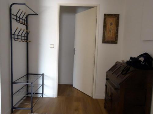 a room with a door and a shelf and a staircase at Harmonie in Pau