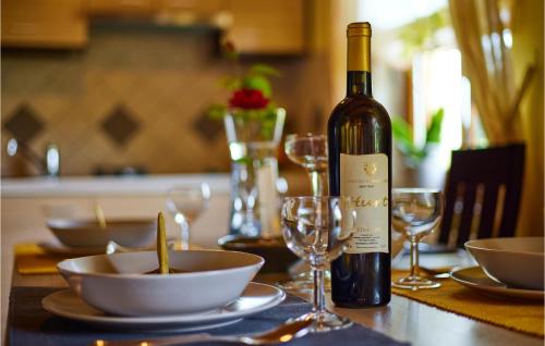 a bottle of wine sitting on a table with glasses at 2 Bedroom Nice Home In Donja Stubica in Donja Stubica
