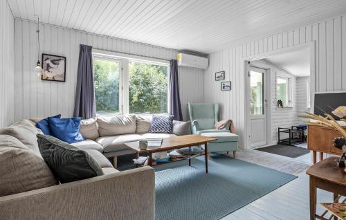a living room with a couch and a table at Awesome Home In Højby With Wifi in Højby