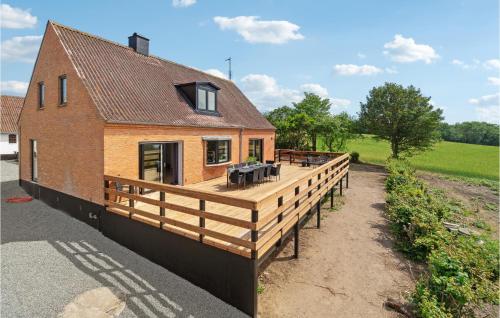 a house with a wooden deck on the side of it at Gorgeous Home In Hasle in Hasle