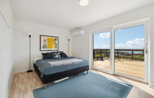 a bedroom with a bed and a large window at Gorgeous Home In Hasle in Hasle