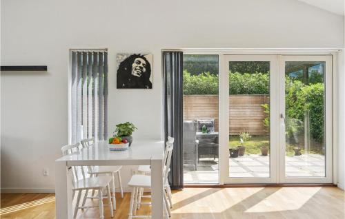 a white dining room with a white table and chairs at Amazing Home In Glostrup With Wifi in Glostrup