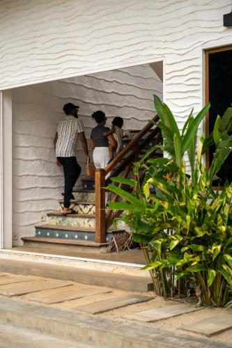 three people walking down the stairs of a house at Triton Dondra in Dondra West