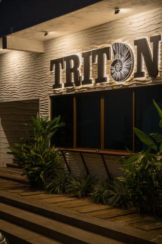a hotel sign on the side of a building at Triton Dondra in Dondra West