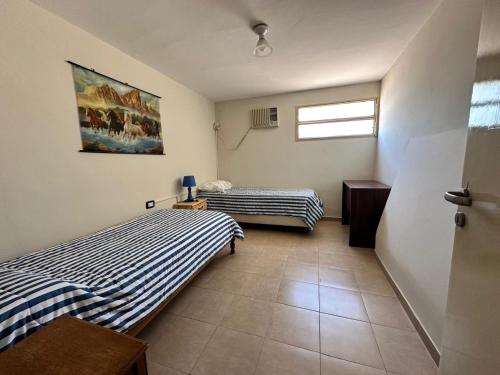 a bedroom with two beds and a window at Casa los girasoles in La Rioja