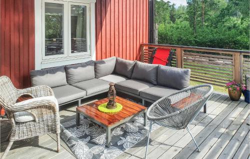 a patio with a couch and chairs and a table at Beautiful Home In Vimmerby With Kitchen in Vimmerby