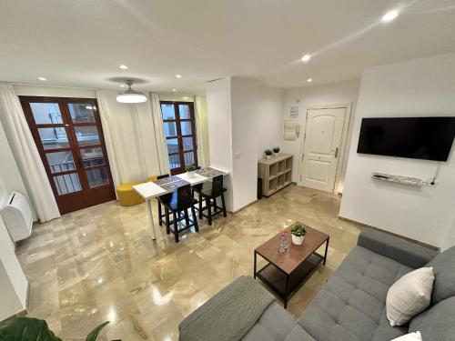 a living room with a couch and a table at Colcha Suites in Granada