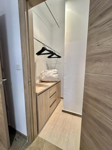 a walk in closet with a wooden cabinet at Colcha Suites in Granada