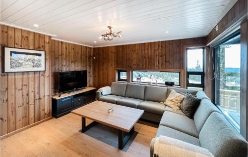 a living room with a couch and a table at Cozy Home In Sjusjøen With Kitchen in Sjusjøen
