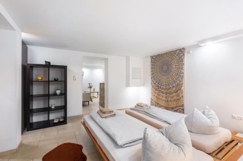 a living room with two beds and a rug at Living the Green in Friedrichsdorf