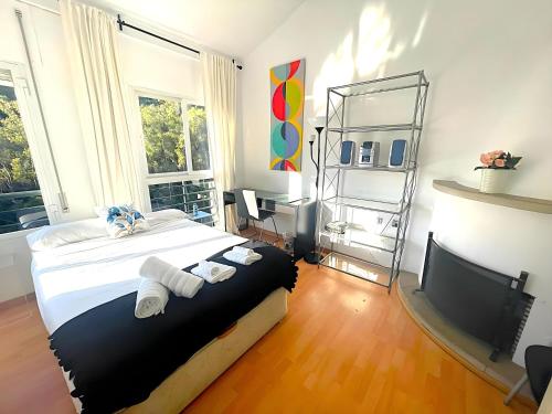 a bedroom with a large bed and a television at Malaga Cozy House- Nature in Málaga