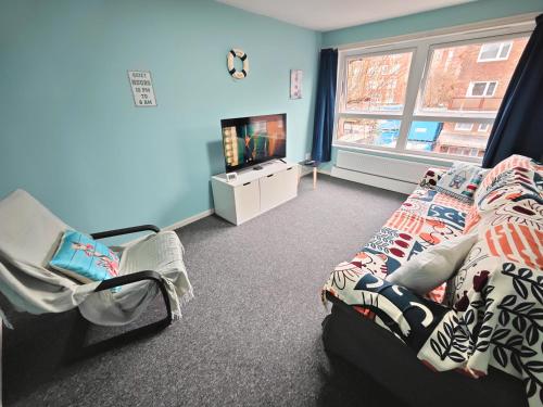 a bedroom with a bed and a tv and a window at 2 Bedroom Flat Next to Lord's Cricket Ground, Central London in London