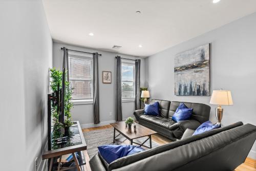 a living room with a couch and a table at Furnished Apartment Near Logan Airport in Boston