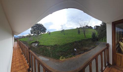 a balcony with a view of a green hill at Matzuri Nekazal Turismoa in Mutriku