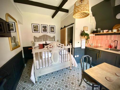 a kitchen with a crib in a room with a table at No 56-Self contained boutique studio in Southwell in Southwell
